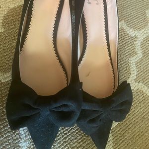 Faux suede kitten heel pumps with bow detail.